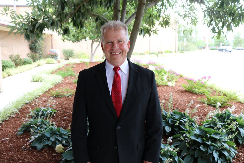 Legacy Chaplain David Riggs standing in the garden at Legacy Village